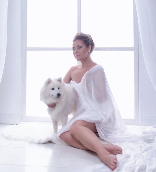 Woman with a calm and focused expression in a dark, minimalist setting.